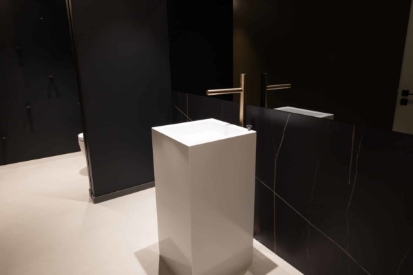 Mobilier design dans des toilettes avec mur en carrelage imitation marbre. Travaux effectué à Rolle