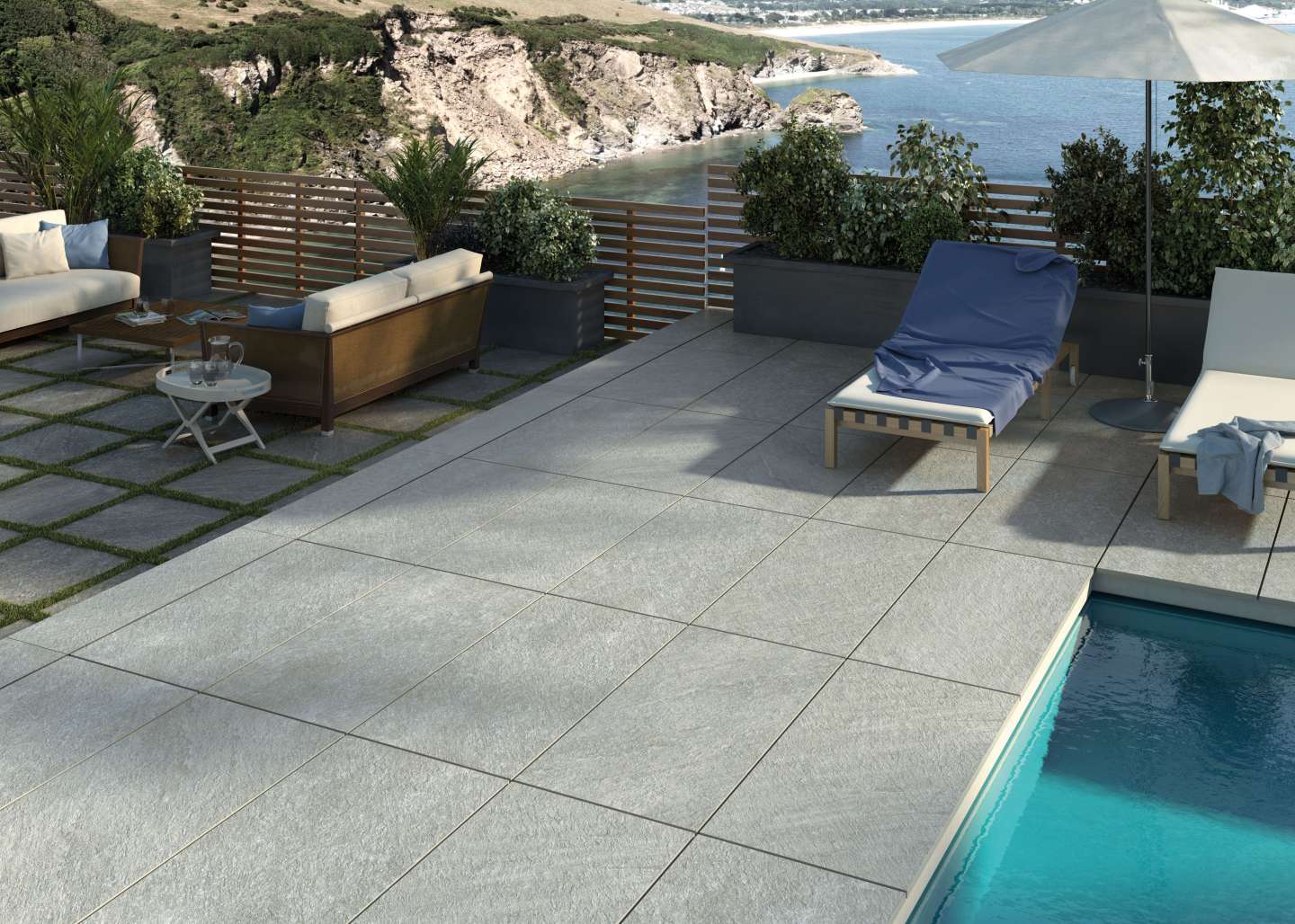 Terrasse avec sol en carrelage imitation pierre Quartz stone de couleur grise et piscine à côté